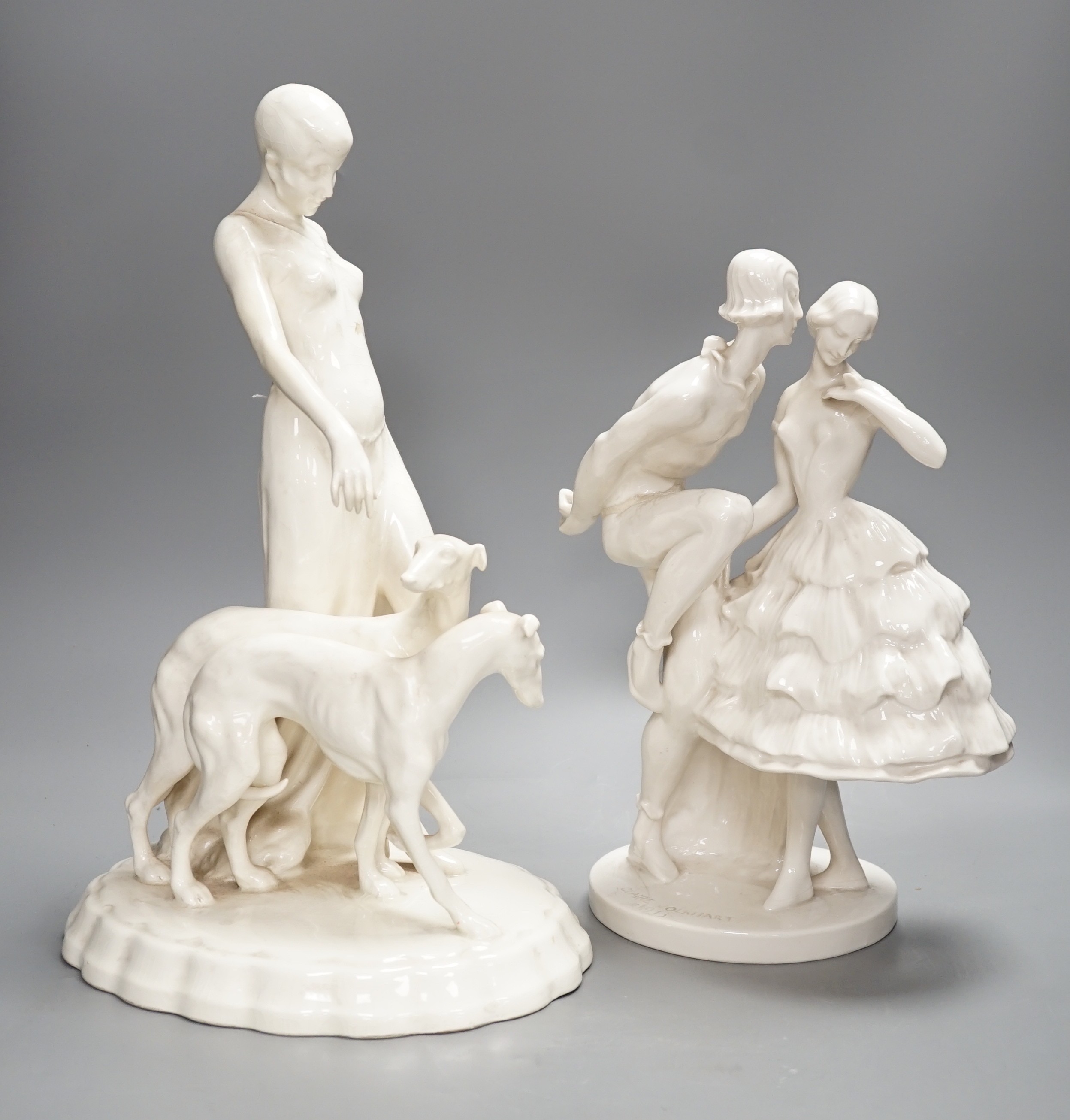 A Royal Dux Art Deco white glazed group modelled as a flapper with two greyhounds, no. 14212, and a Schwarzberger Werkstatten for Porzellankunst group modelled by Claire Volkhart Tallest 41cm